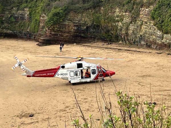 A coastguard helicopter was landed on beach. Photo: RNLI.