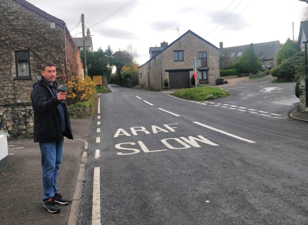 Road action group member Paul Bryant checks on the speed of a car as it approached ‘the narrows’.