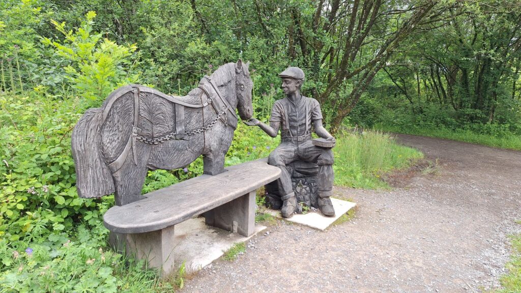 Glamorgan Star news - Wooden sculpture of a miner and pit pony at Parc Slip. Photo by Joy Strangward.