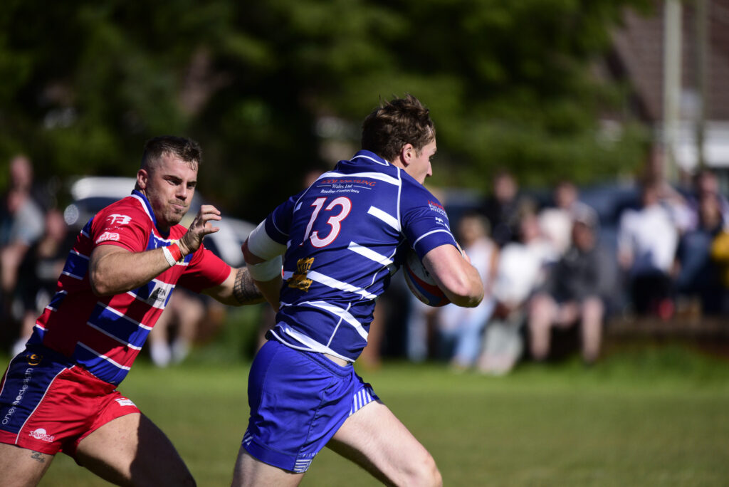 Jordan Bissett moves in to tackle a Heol-y-Cyw attacker. Photo: Julie Hancock.