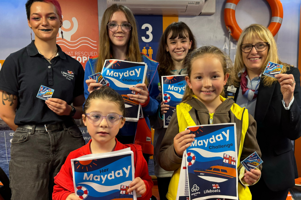 (Left) Katie Phillips, RNLI Volunteer Lifeboat Crew at Barry Dock and (right) Girlguiding Cymru deputy chief commissioner Sarah-Jane Burns along with children representing Rainbows, Brownies, Guides and Rangers from Girlguiding Barry East and the Vale of Glamorgan. Photo: RNLI/Anya Walton.