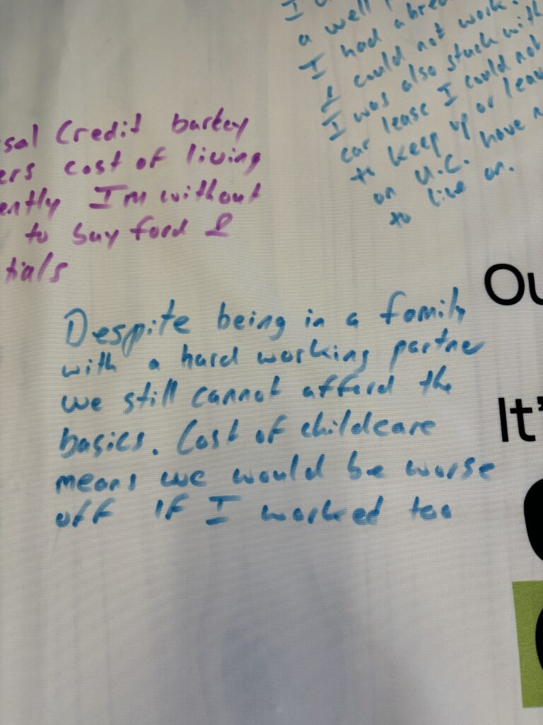 Messages on a tablecloth from Foodbank users.
