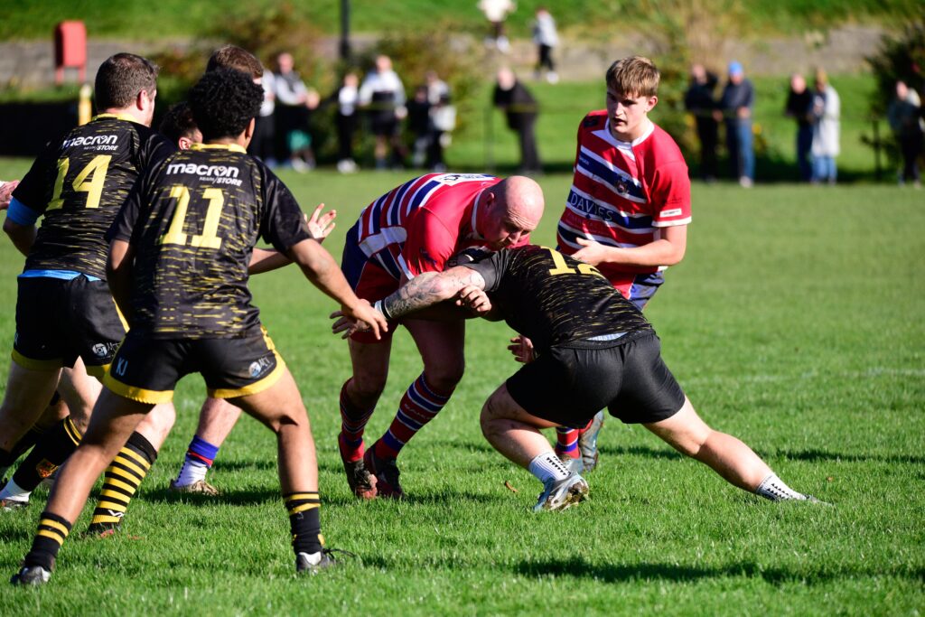 A Maesteg Celtic player tackles Rhys Pilliner.