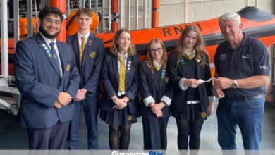 Stanwell School sixth form pupils presenting a £2,000 cheque to the chairman of Penarth RNLI, Laurie Pavelin.