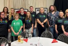 Brilliant MC Huw Williams Jones (left) and special guest Adam Jones, joined by Velindre’s very own Kylie and the hard-working volunteers with Lisa Morgan (front right).