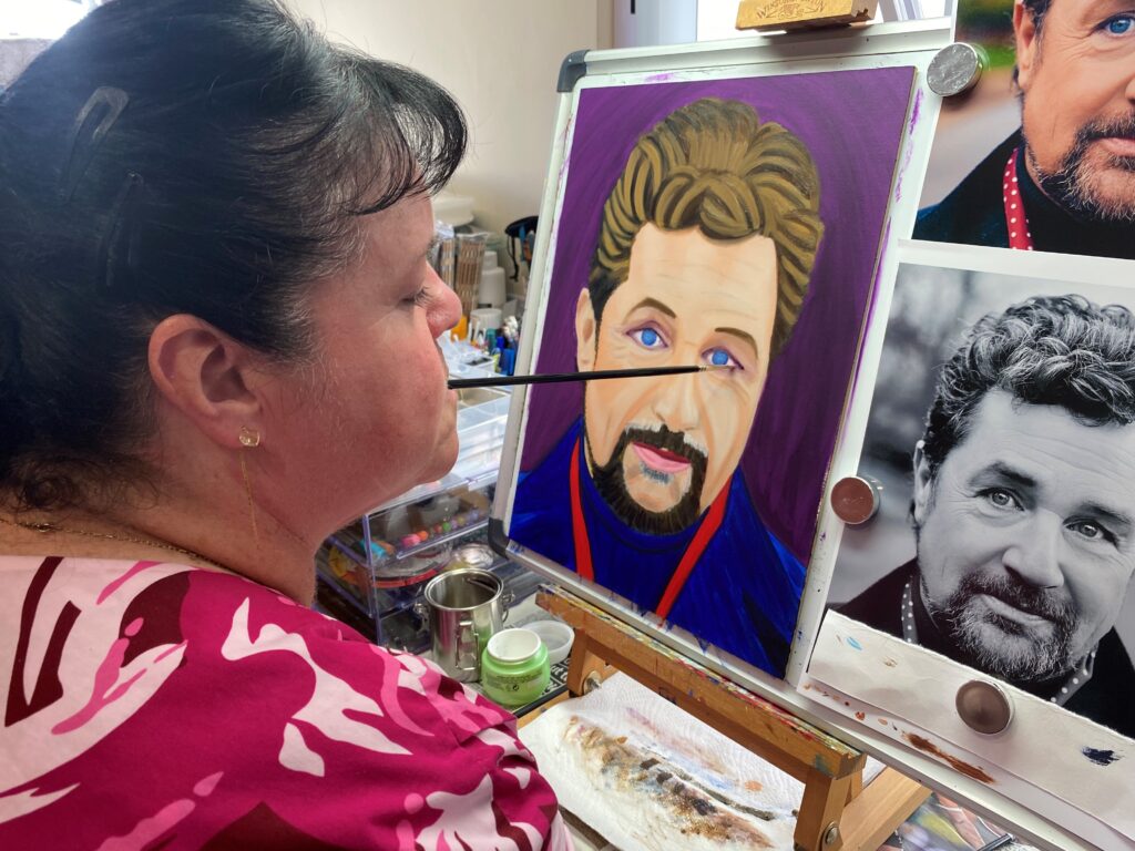 Rosaleen working on her portrait of singer Michael Ball.