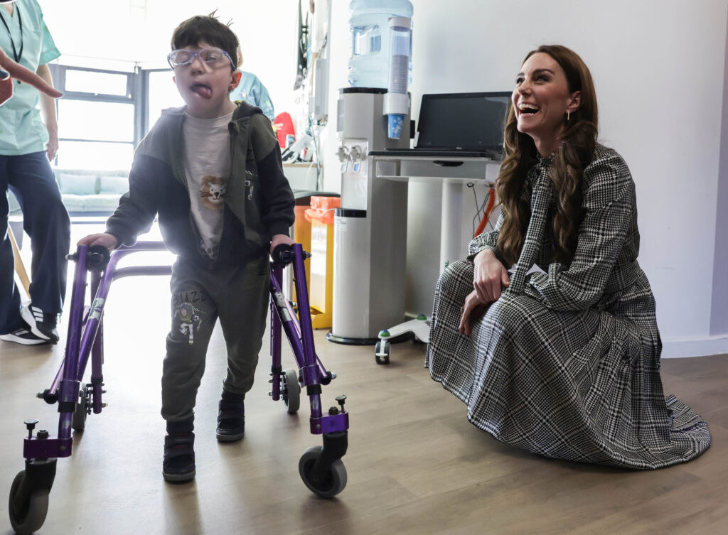 Catherine laughing as she speaks with Oscar aged five who walks with the aid of a walking frame Photo: Andrew Parsons / Kensington Palace