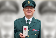 Gerry Adams at Buckingham Palace with his MBE.