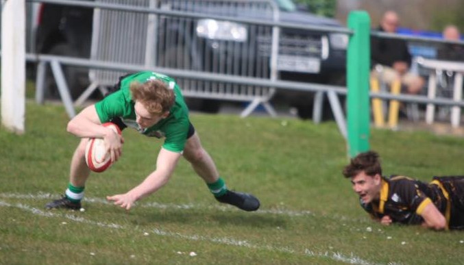 Tyler Reinholdt evades a tackle to score. Photo by Judith Dutton.