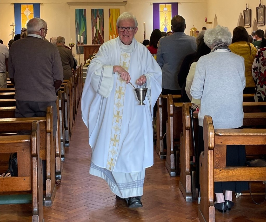 Canon Pat with his congregation.