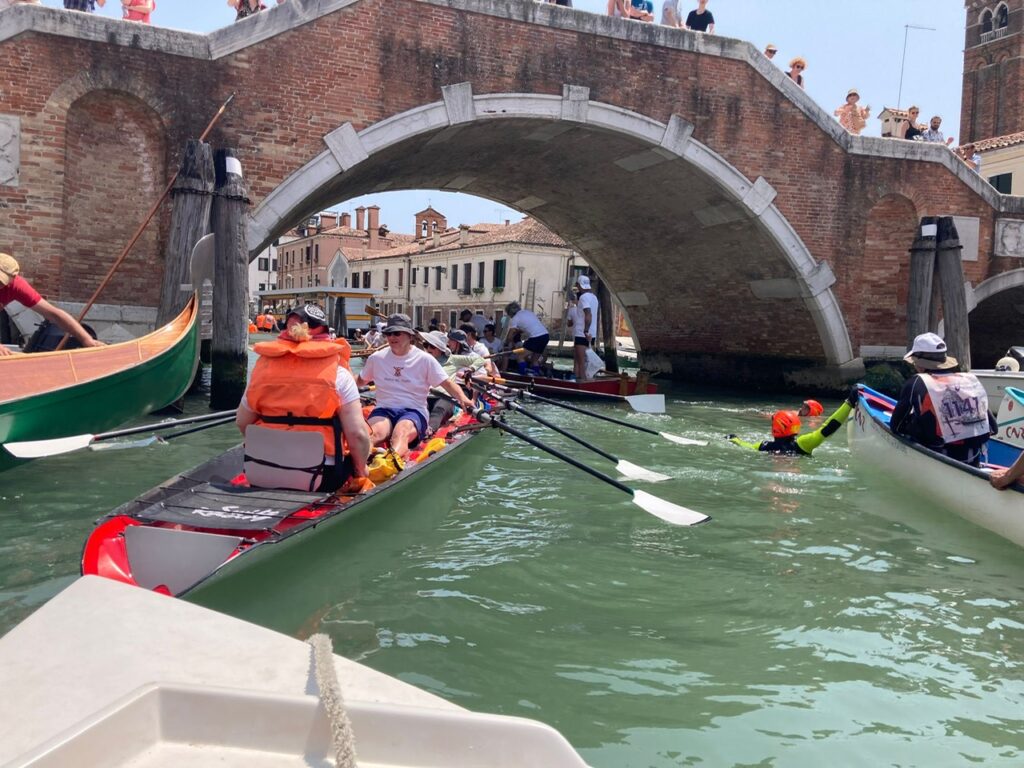 Heading under a Venetian bridge.
