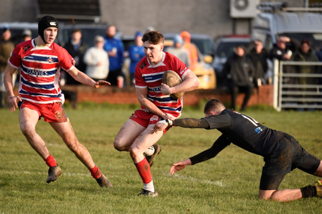 The Watkins family player of match Iwan Powell evades a Neath Athletic tackler. Photo by Julie Hancock https://juliehancock.org.