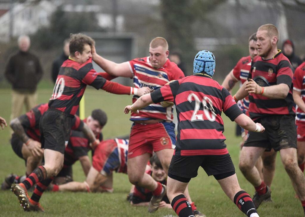 Pencoed’s Harley Moore hands off the Morriston outside half.