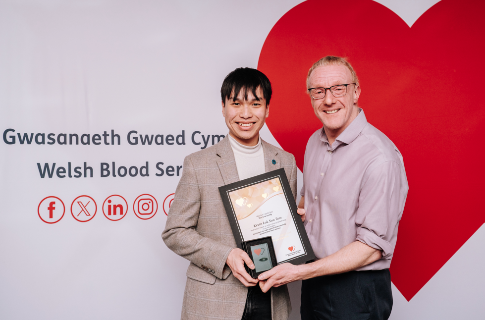 Kevin receiving a certificate to mark being the first Welsh ‘swab kit’ match.