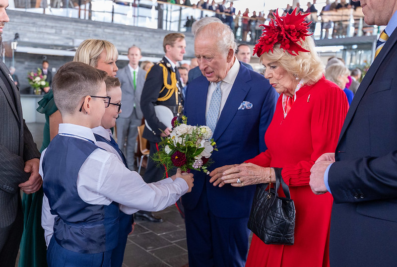 Noah Jones with brother Charlie presented a posy to Queen Camilla. Photo: Welsh Parliament
